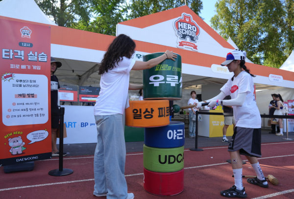 ▲ 한 참가자가 게임용 망치로 피로를 날려버리는 체험 이벤트에 참여하고 있다.