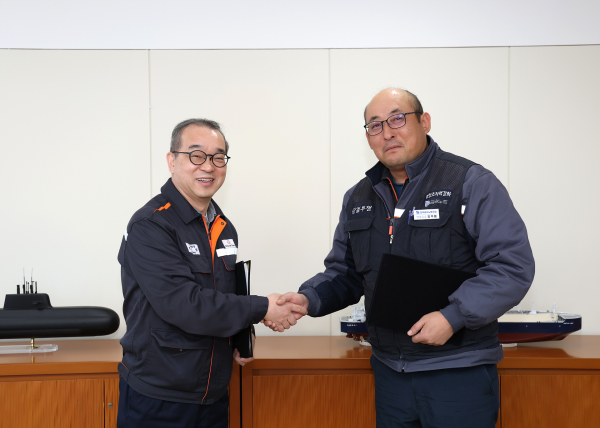 한화오션 경영지원실장 정인섭 사장(왼쪽)과 전국금속노조 경남지부 한화오션지회 강주용 수석부지회장(오른쪽)이 발전적인 노사관계 구축을 위한 합의서에 서명한 뒤 악수하고 있다. [사진=한화오션]